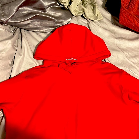 I’m selling a red and white supreme hoodie worn once